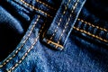 Close-up texture of blue denim stitched with orange thread Royalty Free Stock Photo