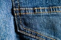 Close-up texture of blue denim stitched with orange thread Royalty Free Stock Photo