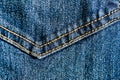Close-up texture of blue denim stitched with orange thread Royalty Free Stock Photo