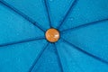 Close-up texture of a bright blue umbrella covered in raindrops. Royalty Free Stock Photo