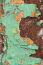 Close Up texture of Chipped peeling green paint over rust, cover