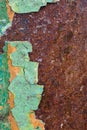 Close Up texture of Chipped peeling green paint over rust, cover