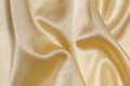 close-up texture of golden cloth crumpled and wrinkled. background for your design. material for sewing