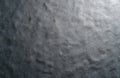 Close up texture of gray felt fabric with subtle creases and light reflections. This material surface has a soft, slightly rough Royalty Free Stock Photo