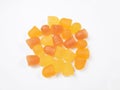 Close-up texture of orange and yellow multivitamin gummies on white background. Healthy lifestyle concept