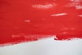 Close up Texture Red color paint on white colour canvas Brush marks stroke for paper graphic design on background Royalty Free Stock Photo