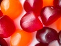 Close-up texture of red, orange and purple multivitamin gummies. Healthy lifestyle concept