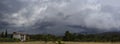 Close-up texture of roPanoramic view of the village, mountains and sky with black storm clouds before the spring storm on the isla Royalty Free Stock Photo