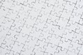 Close up texture of a white jigsaw puzzle in assembled condition. Top view. Many components of a large whole mosaic are united Royalty Free Stock Photo