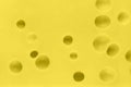 Close up texture of yellow cheese. Cheese with big holes. Food background Royalty Free Stock Photo