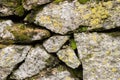 Close-up Textured background irregular natural stone wall is made of different stones with elements of natural Royalty Free Stock Photo