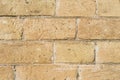 Close-up Textured background of a stone brick of yellow antediluvian masonry. Partially destroyed wall. Brick grunge