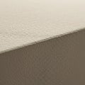 Close-up of a textured, beige surface, likely the corner of an object, possibly a book Royalty Free Stock Photo