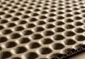 A close-up of a textured cardboard surface with a honeycomb pattern Royalty Free Stock Photo