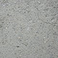 Close-up of a textured concrete surface with visible aggregate and small stones embedded throughout. Royalty Free Stock Photo