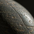 Close-up of a textured, dark gray surface with visible cracks and fine details. The lighti Royalty Free Stock Photo