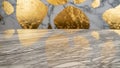 Close-up of a textured marble surface with dramatic golden leaf inclusions and reflected light patterns Keywords Royalty Free Stock Photo
