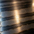 Close-up of a textured metal surface with horizontal, irregular dark stripes. The surface has Royalty Free Stock Photo