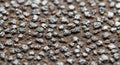 Close-up of a textured sandpaper surface, featuring small, shiny, black abrasive Royalty Free Stock Photo