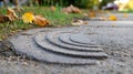 Curved Textured Cement Block Sits on Sidewalk in the Late Afternoon Royalty Free Stock Photo