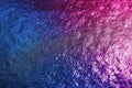 A close-up of a textured surface with a gradient of blue to purple, sprinkled with glittering particles. Royalty Free Stock Photo