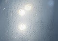 Close-up of a textured surface reflecting light, creating bright circular spots. The surface Royalty Free Stock Photo