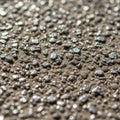 Close-up of a textured surface with small, irregularly shaped pebbles embedded in a concrete-like Royalty Free Stock Photo