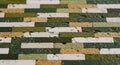 Close-up of a Textured Wall Made of Rectangular Bricks in Green Beige and White Tones background Royalty Free Stock Photo