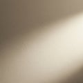 A close-up of a textured wall with a smooth beige plaster finish. Subtle shadows creat Royalty Free Stock Photo