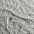 A close-up of textured white fabric or paper, characterized by intertwined fibrous threa Royalty Free Stock Photo