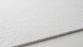 Close-up of a textured white paper sheet, showcasing its fibrous surface Royalty Free Stock Photo