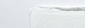 Close-up of textured white toilet paper edge against smooth white background Royalty Free Stock Photo