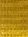 Close-up of textured yellow fabric with a soft grid pattern. Royalty Free Stock Photo