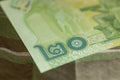 Close up of Thai banknote Thai bath with the image of Thai King. Thai banknote of 20 Thai baht on Green Scottish fabric. Royalty Free Stock Photo