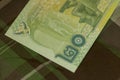 Close up of Thai banknote Thai bath with the image of Thai King. Thai banknote of 20 Thai baht on Green Scottish fabric. Royalty Free Stock Photo