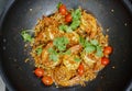 Close up Thai deep fried shrimps with garlic cherry tomatoes and coriander on a pan  Top view of deep fried shrimps with garlic Royalty Free Stock Photo