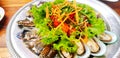 Close up Thai papaya style and vegetable salad with seafood, fresh mussel, prawn and blue crab