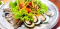 Close up Thai papaya style and vegetable salad with seafood, fresh mussel, prawn and blue crab Royalty Free Stock Photo