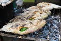 Close up of thai street food barbecue with salted fishes on charcoal grill - Bangkok, Thailand Royalty Free Stock Photo