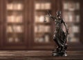 Close up of themis, justice woman figure on a desk