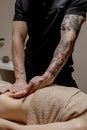 Close up of therapist doing stomach massage on woman in spa
