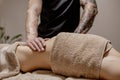 Close up of therapist doing stomach massage on woman in spa