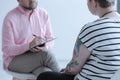 Close-up of a therapy specialist taking notes while listening to Royalty Free Stock Photo