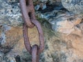 Close up Thick Rusty Chain Background Image. Old rusty metal chain on stone surface Royalty Free Stock Photo