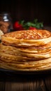 Close up of thin pancakes stacked on a rustic wooden plate