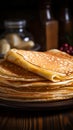 Close up of thin pancakes stacked on a rustic wooden plate