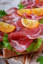 Close-up of thin slices of Italian cold cut pork Coppa on slices of grain bread