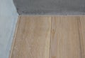 Close up on thin solid wooden skirting boards. Natural wooden floor