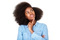 Close up thinking young black woman with afro looking up at copy space Royalty Free Stock Photo