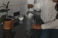 Close-up thirsty african american woman drinking mineral water in kitchen, pouring healthy liquid from jug to glass